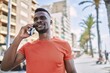 © Krakenimages.com - Young african american man smiling confident talking on the smartphone at street