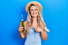 Beautiful Young Blonde Woman Holding Olive Oil Smiling Happy Pointing With Hand And Finger