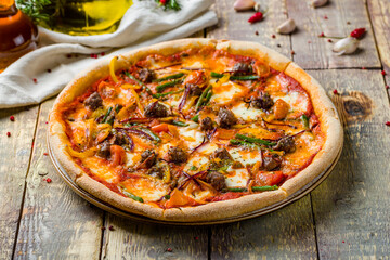Wall Mural - Italian meat pizza with beef on wooden table