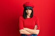 © Krakenimages.com - Young hispanic woman wearing french look with beret skeptic and nervous, disapproving expression on face with crossed arms. negative person.