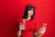 © Krakenimages.com - Young hispanic woman using smartphone and drinking a cup of coffee depressed and worry for distress, crying angry and afraid. sad expression.