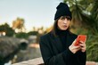 © Krakenimages.com - Young hispanic woman with serious expression using smartphone at the city.