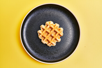 Wall Mural -  Plate of delicious waffle over yellow background