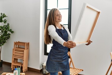 Poster - Young caucasian woman smiling confident looking canvas draw at art studio