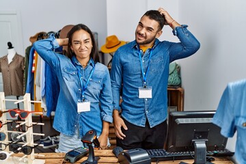 Canvas Print - Young interracial people working at retail boutique confuse and wonder about question. uncertain with doubt, thinking with hand on head. pensive concept.