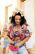 © kleberpicui - Care during Carnival. Young woman using sunscreen during carnival block