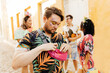© kleberpicui - Care during Carnival. Man using sunscreen during carnival block