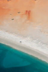 Four wheel drive vehicles sit on an Indian Ocean beach south of Cape Leveque in the Broome region of Western Australia in Australia. This region is also known as the West Kimberley.