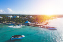 Dominicus Beach At Bayahibe With Caribbean Sea, Sandy Seashore And Pier At Sunset. Aerial View