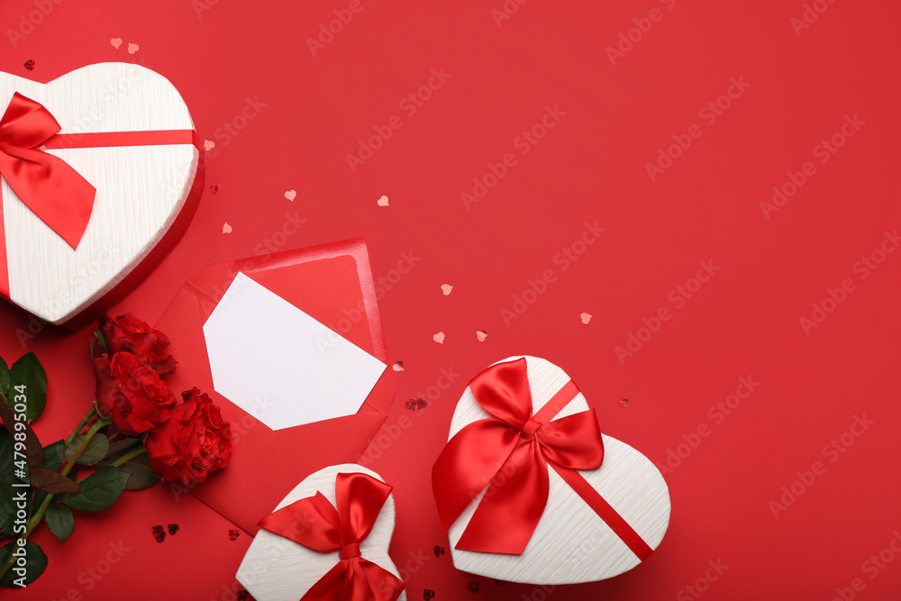 Gift boxes for Valentine's Day with envelope and roses on red background