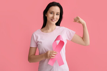 Canvas Print - Young woman with ribbon on pink background. Breast cancer awareness concept