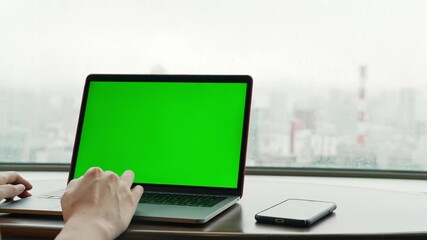 Aufkleber - People using a laptop PC in the room. Green screen for chroma key composition.