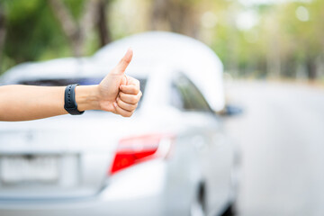 Wall Mural - Close-up of woman's hand, Asian young woman opened the hood broken car on the road Searching for help The car is coming.