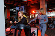 © Дмитрий Ткачук - Young slender woman in the gym performs exercises under the guidance of an experienced trainer. Sports for a healthy body
