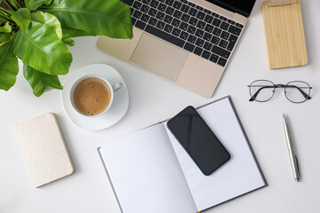 Canvas Print - Office stationery, laptop and smartphone on white table, flat lay