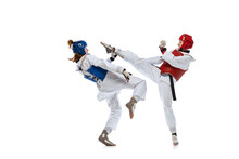 Portrait Of Two Young Women, Taekwondo Athletes Practicing, Fighting Isolated Over White Background. Concept Of Sport, Skills
