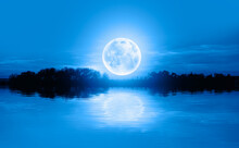 Calm Water Of Blue Lake With Full Blue Moon "Elements Of This Image Furnished By NASA"
