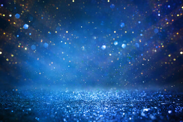 background of abstract glitter lights. gold, blue and black. de focused