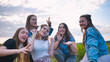 © Довидович Михаил - A group of girls of friends are listening to music on headphones and dancing to a friend.