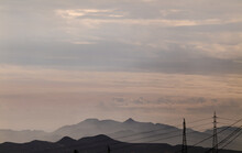 Transmission Towers Against Mountains With Cloudy Sky In Almeria, Spain