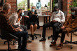 © DC Studio - People with addiction meeting at aa group therapy session to receive counseling from therapist. Patients with face masks attending aa support program during covid 19 pandemic.