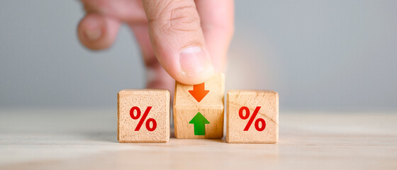 Interest rate financial and mortgage rates concept. Hand flip wood cube change arrow down to up