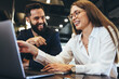 Leinwandbild Motiv Successful businesspeople smiling while working together