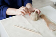 © Dina - woman sculpting a pumpkin out of clay with tools - hobby and DIY project at home hands close up