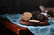 Cut black truffles on dark brown vintage background. Selective focus, free text space.