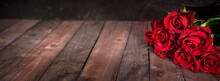 Bouquet Of Red Roses On Dark Vintage Planks. Horizontal Background For Romantc Valentine's Day Greetings With Space For Text.