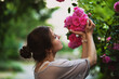 Beautiful woman holding heart shaped bouquet of pink roses