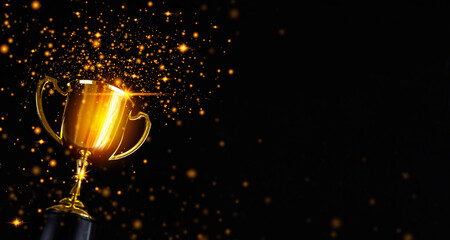 champion golden trophy isolated on black background.