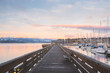 Sunset or sunrise at the waterfront boardwalk and marina on a cold winter day at Comox Harbour, British Columbia, Canada.