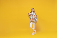 Full Body Little Blonde Caucasian Kid Girl 13-14 Years Wearing Checkered Shirt Hold Takeaway Delivery Craft Paper Brown Cup Coffee To Go Isolated On Plain Yellow Background. People Lifestyle Concept.