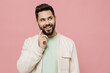 © ViDi Studio - Young minded happy caucasian man 20s in trendy jacket shirt prop up chin look aside on workspace area mock up isolated on plain pastel light pink background studio portrait. People lifestyle concept.