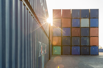 Wall Mural - Stack of containers in a harbor. Shipping containers stacked on cargo ship. Background of Stack of Containers at a Port.