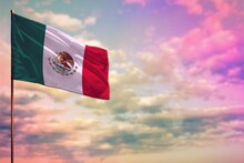 Fluttering Mexico Flag Mockup With The Space For Your Content On Colorful Cloudy Sky Background.