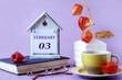 Calendar for February 3: the name of the month in English, the numbers 03, a yellow cup of tea, a physalis branch in a vase, a book, glasses on a pastel background