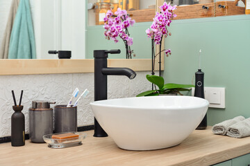 Stylish vessel sink with black basin mixer