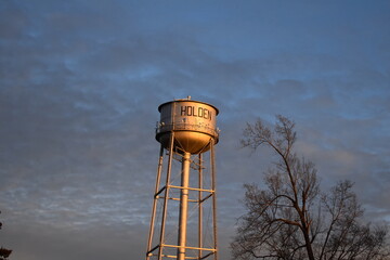 Canvas Print - Water Tower Under a Blue Cloudy Sky