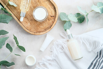 Wall Mural - natural cosmetic products set with eucalyptus leaves on stone background. spa organic beauty product