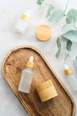 Wall Mural - Natural SPA cosmetics in wooden and glass eco packaging on stone table. Organic bath beauty products collection. Skincare concept.