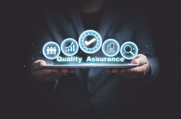Fototapete - Hand holding the best quality assurance with icons on tablet for guarantee product and ISO service concept.