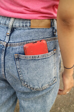 Red Cell Phone In Back Pocket
