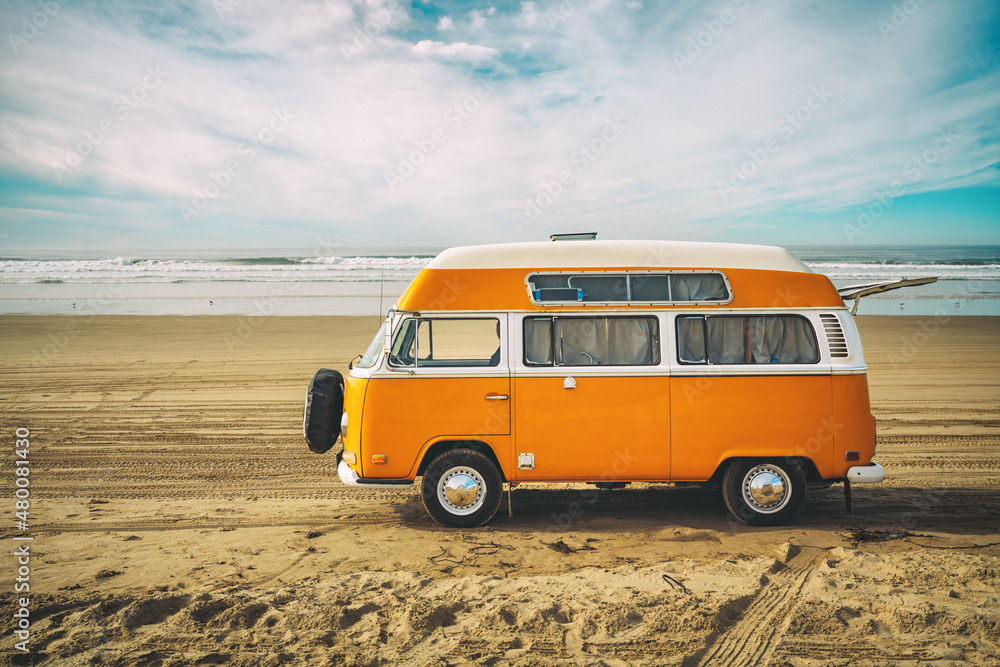 Vintage yellow van on the beach with cloudy sky on background, retro ...