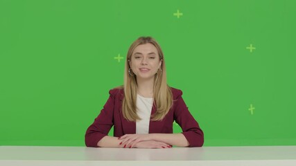 Female news presenter in broadcasting studio over green screen background
