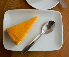 Top view of delicate chiffon cake with mango jelly served on white plate..