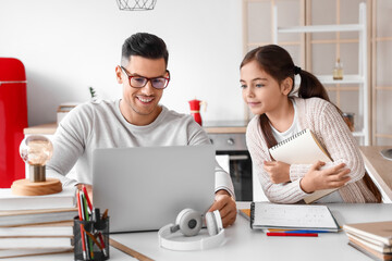 Wall Mural - Little girl studying with tutor at home