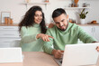 © Pixel-Shot - Happy young couple of freelancers with laptops at home