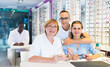 © JackF - Mature woman and adult children choose a spectacles in medical shop